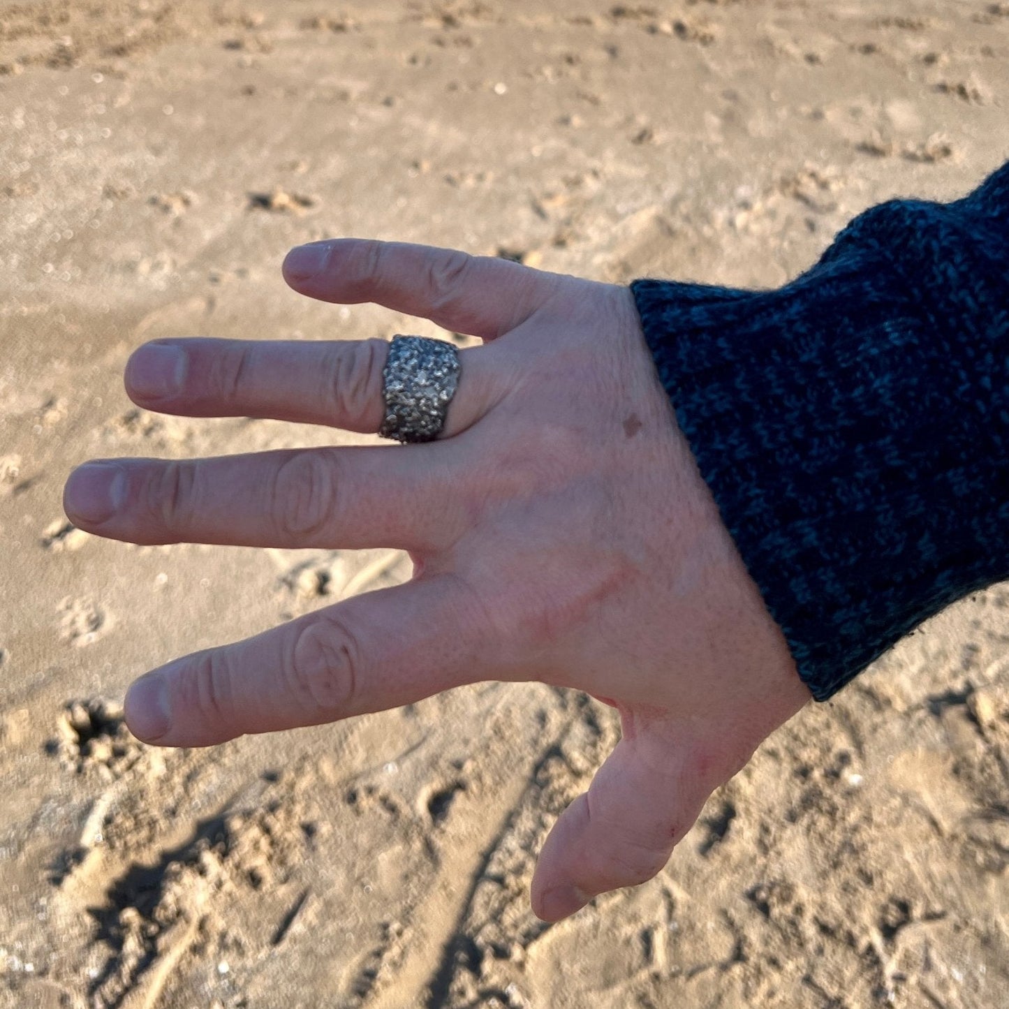 Earth — The Guardian Wide Band Ring in Silver. Handcrafted in fine silver with organic texture on a hand