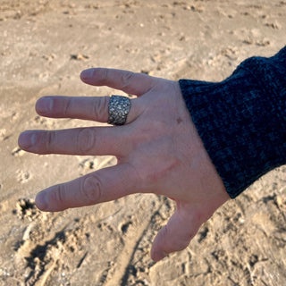 Earth — The Guardian Wide Band Ring in Silver. Handcrafted in fine silver with organic texture on a hand