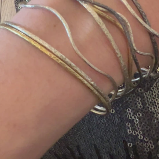 Six elements Goddess collection a set of silver textured bangles on a hand