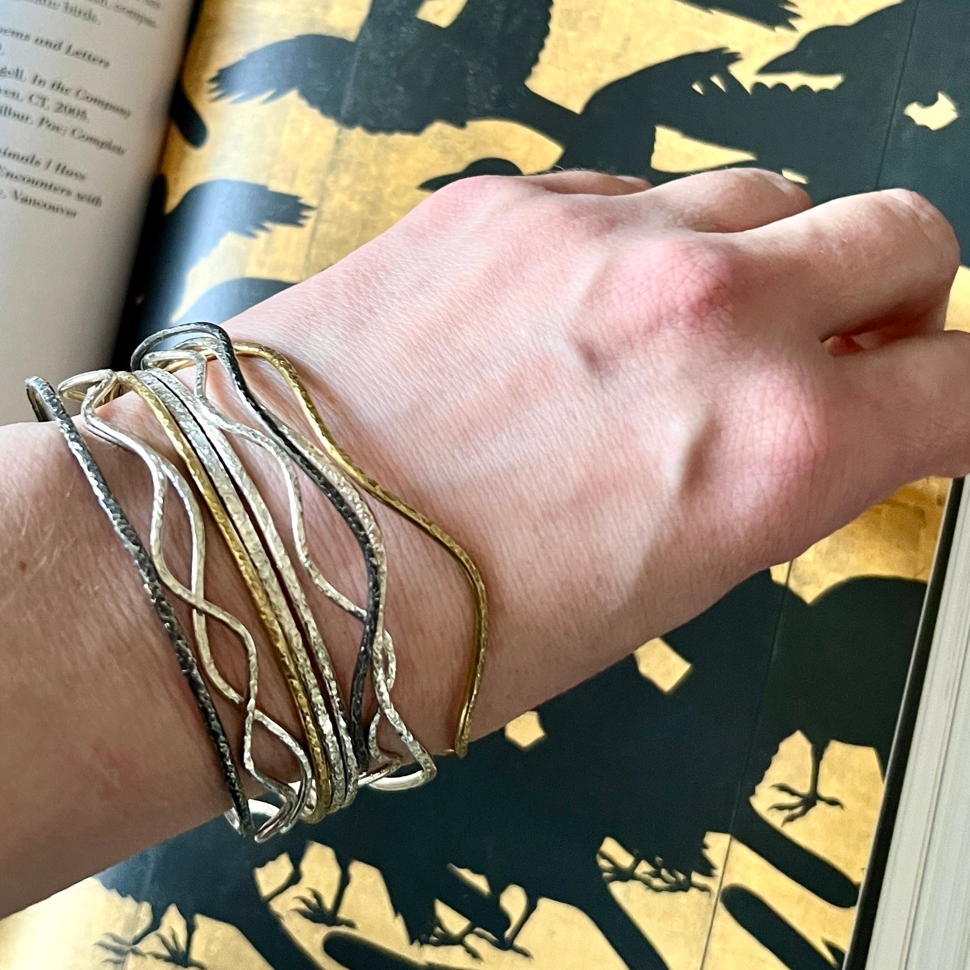 The Everyday Goddess – Wavy Bracelets Trio on a hand : three shimmering finishes, elemental energy from 6 elements Studio