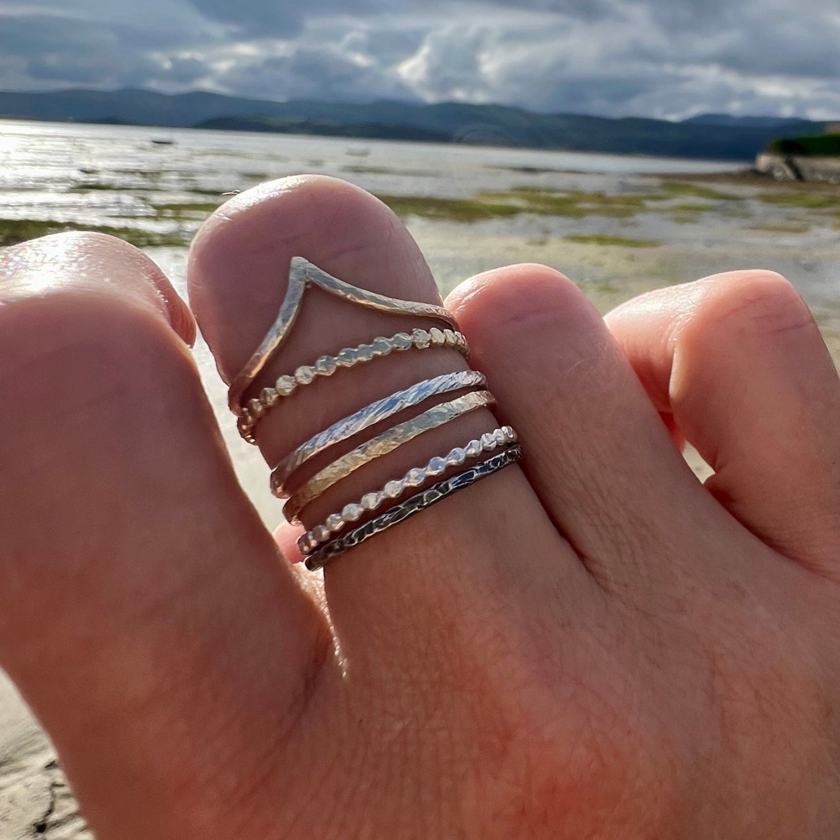 The Rings of Becoming – Stacking Ring Set in Gold and Silver worn on a hand - 6 elements Studio